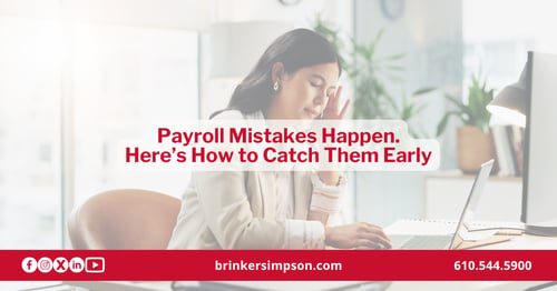 Business owner reviewing payroll records at her desk